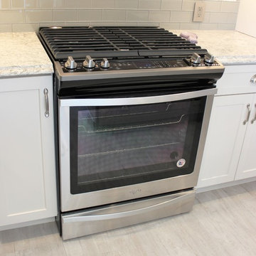 Alpha, IL White and Gray Kitchen with Hidden Laundry and Raised Dishwasher