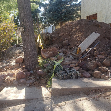 Mountain inspired minimalist boulder retaining walls and plantings.