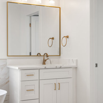 Warm Transitional Two-Room Primary Bathroom