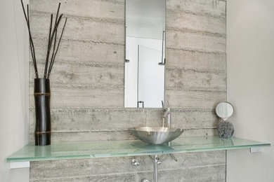 Inspiration for a contemporary black and white tile bathroom remodel in Austin with glass countertops