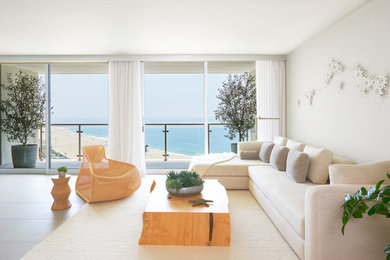Example of a mid-sized trendy open concept porcelain tile and white floor living room design in Other with white walls and no tv