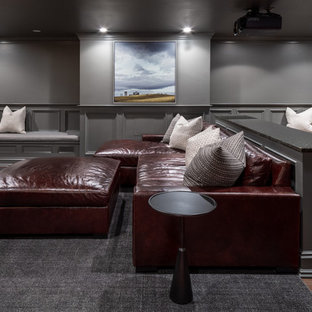 Photo of a farmhouse enclosed home cinema in Boston with grey walls, a wall mounted tv, dark hardwood flooring and brown floors.