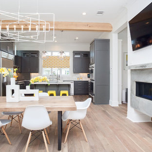 Design ideas for a contemporary dining room in New Orleans with a concrete fireplace surround.