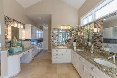 Bathroom - large coastal master beige tile, brown tile, white tile and matchstick tile ceramic tile and beige floor bathroom idea in Miami with raised-panel cabinets, white cabinets, beige walls, an undermount sink, granite countertops and brown countertops