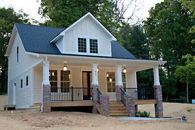 Example of a mid-sized arts and crafts yellow two-story wood gable roof design in Other
