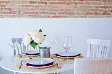 Inspiration for a mid-sized country kitchen/dining combo in Barcelona with white walls.