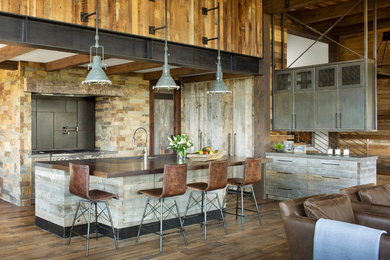 Open concept kitchen - rustic medium tone wood floor and brown floor open concept kitchen idea in Denver with brown backsplash, stainless steel appliances, an island and brown countertops