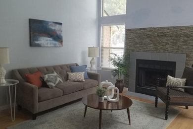 Small transitional loft-style light wood floor and vaulted ceiling family room photo in Denver with blue walls, a standard fireplace and a tile fireplace