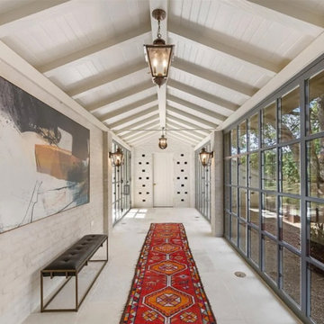 Glass Gallery Hallway with Vaulted Ceiling and Natural Light