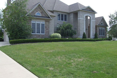 Example of a large classic gray three-story mixed siding exterior home design in Cleveland