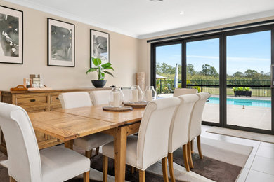 Beach style dining room in Brisbane.