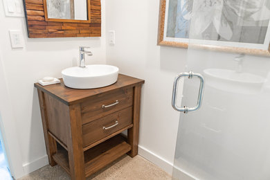 Photo of a bathroom in Other with medium wood cabinets.