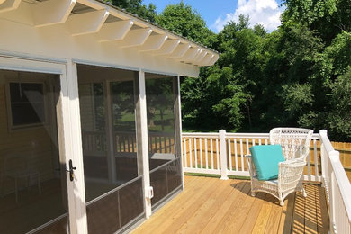 Example of a mid-sized classic backyard deck design in Other with no cover