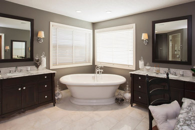 Inspiration for a large timeless master beige tile and ceramic tile marble floor and white floor bathroom remodel in New York with shaker cabinets, dark wood cabinets, a two-piece toilet, gray walls, an undermount sink, marble countertops and a hinged shower door