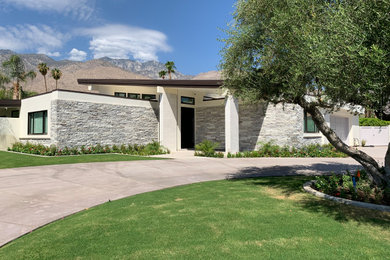Modern one-story stone house exterior idea in Los Angeles with a shed roof