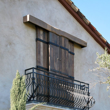 Reclaimed Barn Wood Sliding Shutters in a Rustic Tuscan Style
