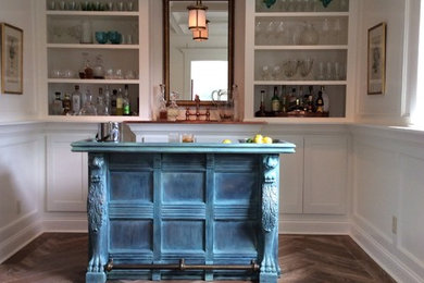 Large transitional galley seated home bar in Indianapolis with recessed-panel cabinets, blue cabinets, wood benchtops, white splashback, dark hardwood floors and turquoise benchtop.
