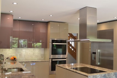 Eat-in kitchen - mid-sized contemporary l-shaped eat-in kitchen idea in Philadelphia with an undermount sink, flat-panel cabinets, beige cabinets, granite countertops, white backsplash, stainless steel appliances and an island