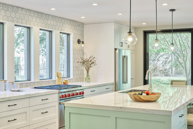 Example of a mid-sized trendy l-shaped open concept kitchen design in Austin with shaker cabinets, white cabinets, stainless steel appliances and an island