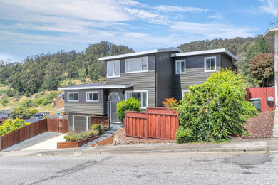 Large gray two-story wood and clapboard exterior home idea in San Francisco with a shingle roof and a black roof