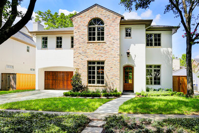 Example of a mid-sized transitional multicolored two-story brick house exterior design in Houston with a hip roof and a mixed material roof