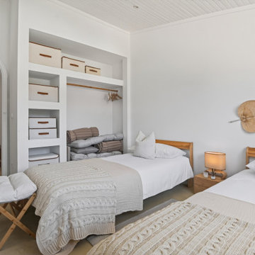 Twin Bedroom with Open Wardrobe and Palm Wall Piece