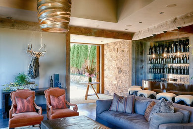 Example of a large trendy open concept concrete floor family room design in San Francisco with beige walls, no tv, a two-sided fireplace and a stone fireplace