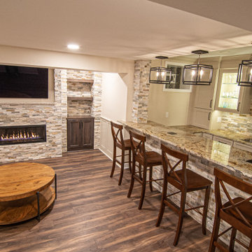 Basement Showing Warm Colors, Straight Lined Cabinets and Stacked Stone