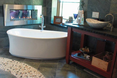 Bathroom - mid-sized contemporary master gray tile and slate tile slate floor and gray floor bathroom idea in San Diego with open cabinets, medium tone wood cabinets, gray walls, a vessel sink and soapstone countertops
