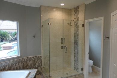 Example of a mid-sized transitional master beige tile and glass tile ceramic tile bathroom design in Houston with shaker cabinets, dark wood cabinets, a two-piece toilet, gray walls, an undermount sink and granite countertops