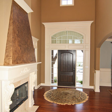 Front Entry with Dark Wood Door and Fireplace