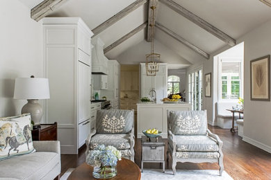 Open concept kitchen - large traditional l-shaped medium tone wood floor and brown floor open concept kitchen idea in Other with an undermount sink, recessed-panel cabinets, white cabinets, marble countertops, white backsplash, stone slab backsplash, paneled appliances and an island