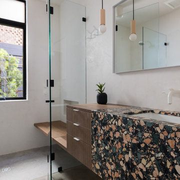 Bathroom with multicolor terrazzo vanity and frameless glass shower - Fold House