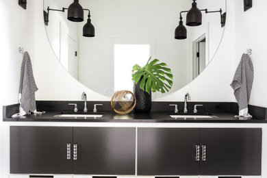 Country bathroom in Oklahoma City with flat-panel cabinets, black cabinets, white walls, an undermount sink, grey floor, black benchtops, a double vanity and a floating vanity.