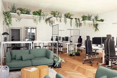 Mittelgroßes Modernes Arbeitszimmer ohne Kamin mit Arbeitsplatz, weißer Wandfarbe, braunem Holzboden, freistehendem Schreibtisch und braunem Boden in Hamburg