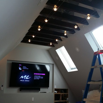 MEDIA ROOM IN AN ATTIC SPACE- EXPOSED INDUSTRIAL A/C- WOOD FLOOR , CEILING BEAMS