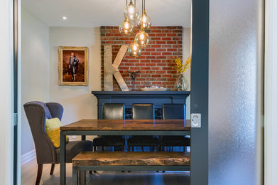 Inspiration for a mid-sized contemporary light wood floor enclosed dining room remodel in Toronto with green walls, a standard fireplace and a brick fireplace