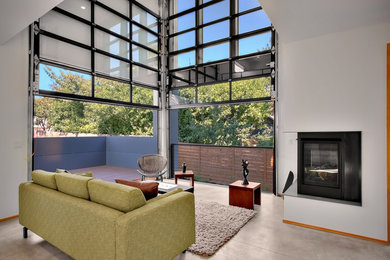 This is an example of a mid-sized contemporary open concept living room in Phoenix with white walls, concrete floors, a corner fireplace and a metal fireplace surround.