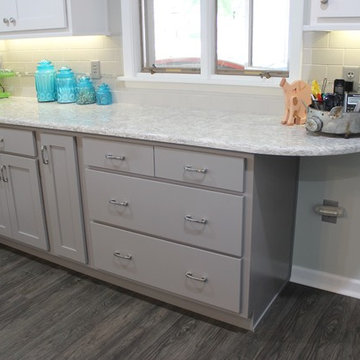 White Upper Cabinet and Gray Base Cabinet Kitchen With Quartz Counters