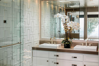Inspiration for a mid-sized transitional master beige tile and ceramic tile porcelain tile and beige floor walk-in shower remodel in Los Angeles with a vessel sink, shaker cabinets, white cabinets, white walls, quartz countertops and a hinged shower door