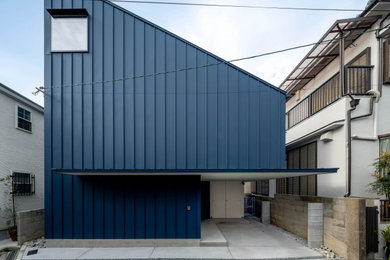 Small modern blue three-story metal and board and batten house exterior idea in Osaka with a shed roof, a metal roof and a blue roof