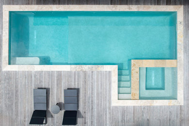 Pool - large contemporary backyard rectangular pool idea in Wilmington