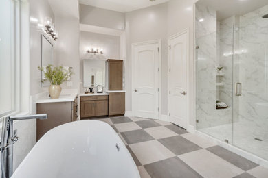 Example of a huge transitional master white tile and porcelain tile porcelain tile, multicolored floor and double-sink bathroom design in Phoenix with shaker cabinets, brown cabinets, gray walls, an undermount sink, quartzite countertops, a hinged shower door, white countertops and a built-in vanity
