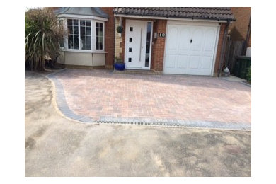 Photo of a medium sized front garden with concrete paving.
