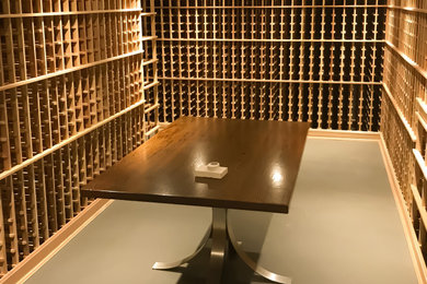 Wine cellar - mid-sized coastal gray floor wine cellar idea in New York