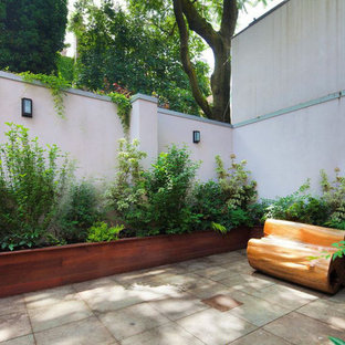Contemporary backyard shaded garden in New York with a container garden and natural stone pavers.