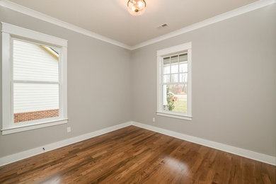 Inspiration for a mid-sized craftsman guest medium tone wood floor bedroom remodel in Other with gray walls