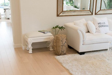 Living room - mid-sized coastal formal and enclosed light wood floor and brown floor living room idea in Miami with white walls, no fireplace and no tv