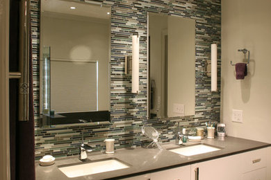 Example of a large trendy master terrazzo floor walk-in shower design in Charlotte with an undermount sink, flat-panel cabinets, white cabinets, quartz countertops, an undermount tub and gray walls
