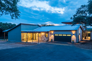 Large transitional green one-story mixed siding exterior home photo in Other with a metal roof
